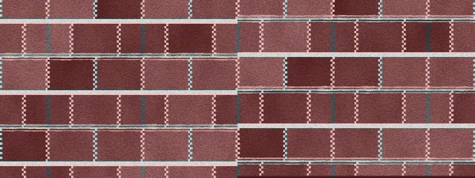 Close-up of a brick wall featuring varying shades of red and brown bricks.