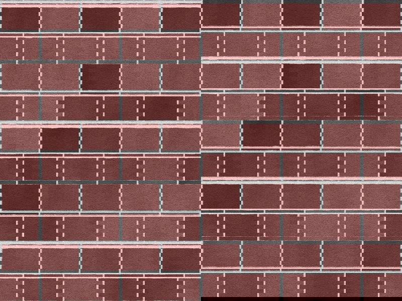 Close-up of a brick wall featuring varying shades of red and brown bricks.