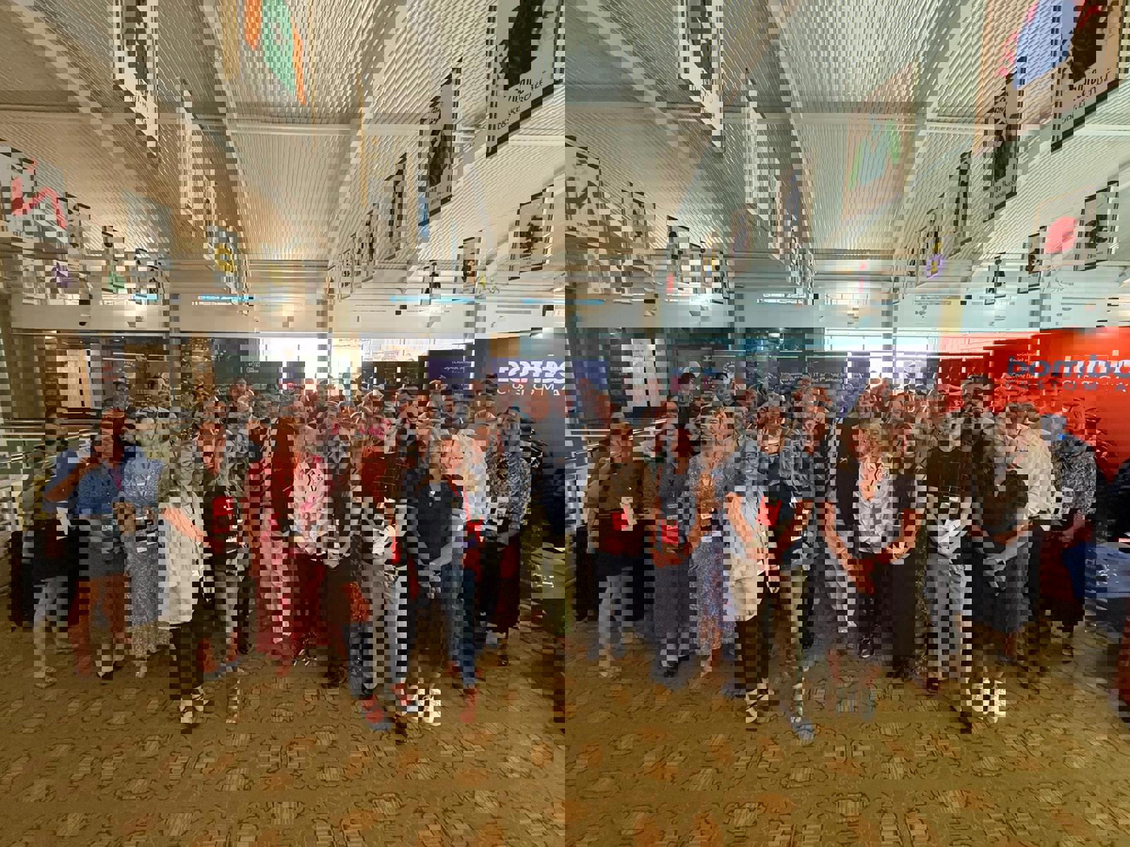 Group photo of attendees at the Business Growth Show, smiling and posing together indoors.